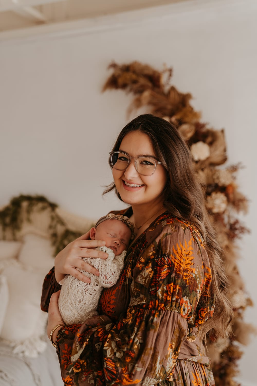 Cailin Thor holding a newborn in her studio